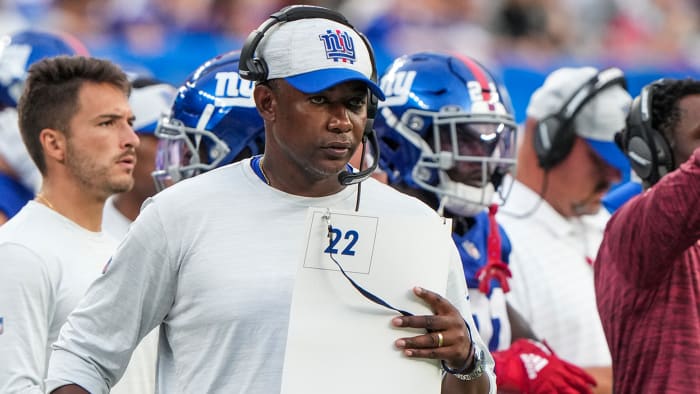 Giants defensive coordinator Patrick Graham looks at his call sheet during a game